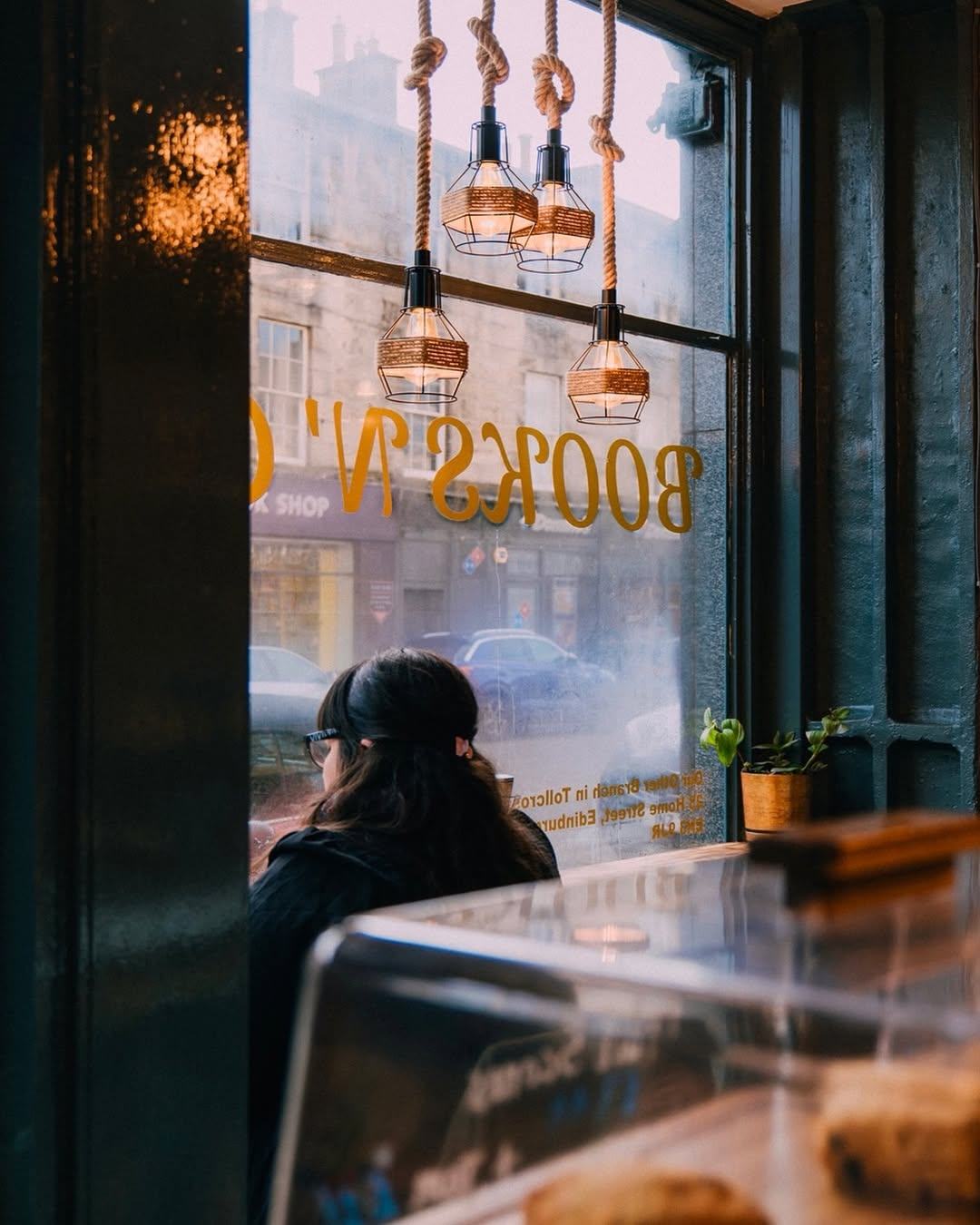 Window seating with hanging pendant lights at Books N' Cup Tollcross